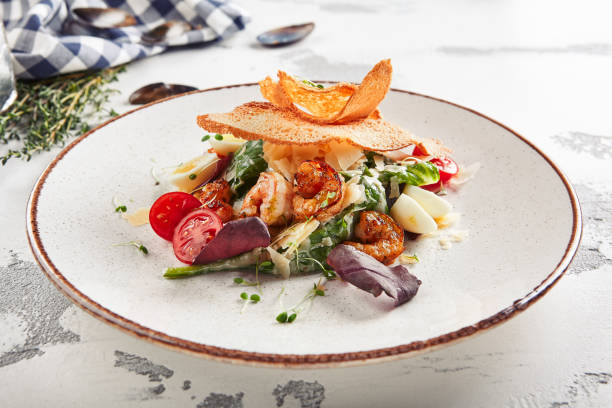 istock Beautiful serving white restaurant plate of caesar salad 1173336059