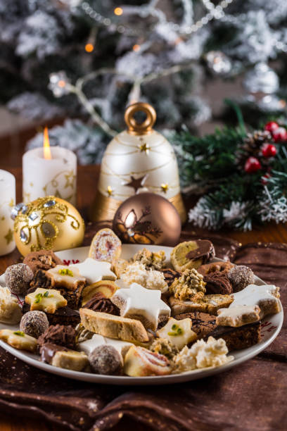 istock Assorted homemade Christmas cookies with candles on the table 1173336837