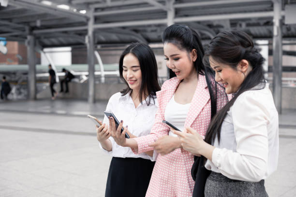 istock Group asian woman playing mobile. 1173336958