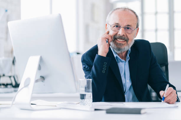 istock Mature businessman talking on phone in modern office 1173337032