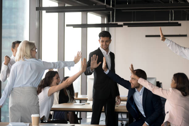 istock Excited team give high five celebrating shared success in office 1173338499