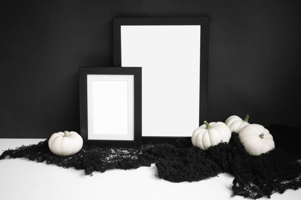 Halloween concept frame mockups with white pumpkins on black background. Minimal mock ups. Halloween styled flat lay katt halloween stock pictures, royalty-free photos & images