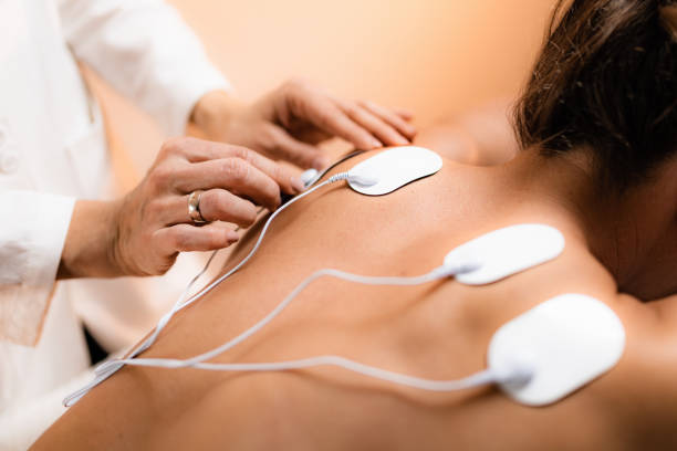 istock Upper Back Physical Therapy with TENS Electrode Pads, Transcutaneous Electrical Nerve Stimulation 1173340662