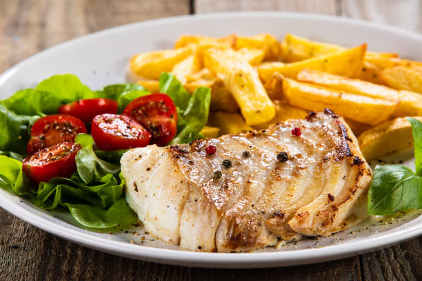 istock Fried cod fillet with French fries and vegetables 1173341998
