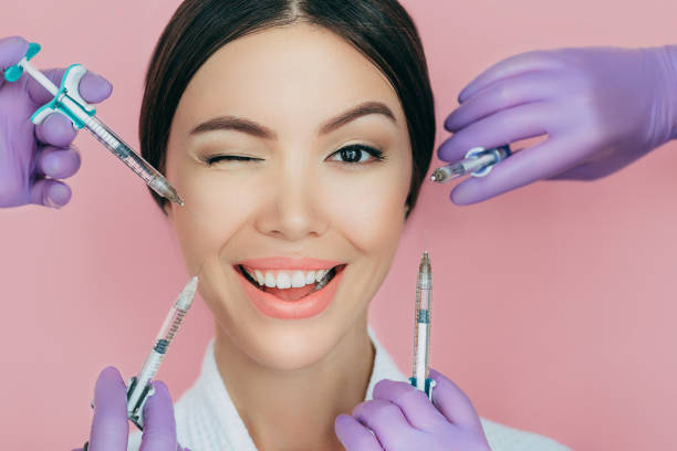 Portrait of a beautiful winking woman and many syringes with beauty injections around her face Portrait of a beautiful winking woman and many syringes with beauty injections around her face hyaluronic acid injections stock pictures, royalty-free photos & images