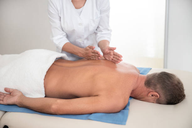 istock Doctor holding hand on back during massage 1173342141