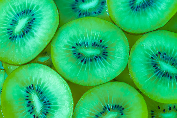Ripe sliced green kiwi fresh fruits. Top view of sliced kiwi as abstract pattern background, flat lay