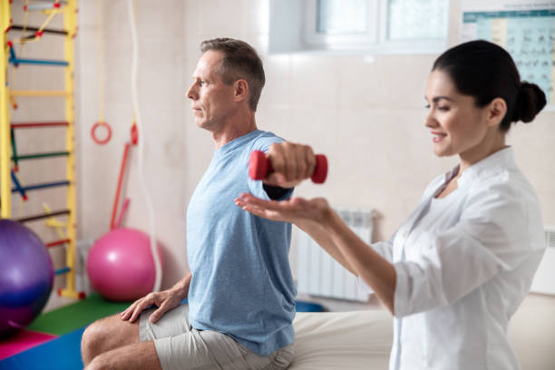 istock Adult man holding hand aside with dumbbell 1173342306