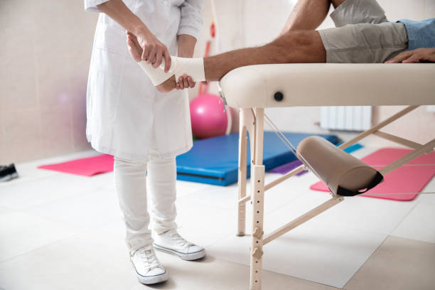 istock Female doctor is doing leg ligation for man 1173342325