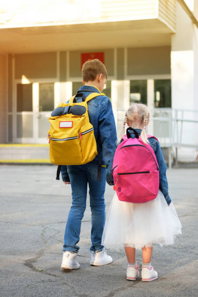 istock Boy with girl hold hand run to school 1173342421