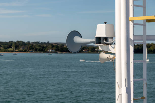 A navigation light at dawn aboard schooner while sailing along in calm ocean waters.