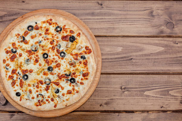 istock Pizza with Mozzarella cheese, chicken, olives, Spices . Italian pizza 1173344156