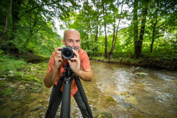 istock friendly photographer behind camera outdoors in river 1173344394