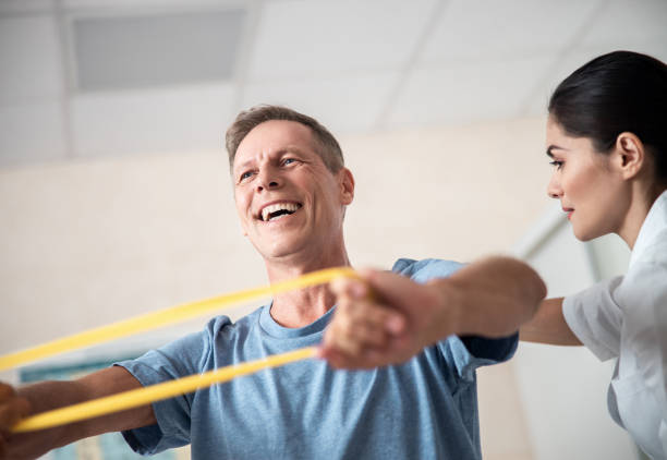 istock Happy male patient is doing rehab exercises 1173345359