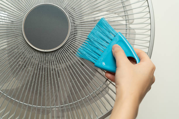 istock Clean the electric fan with a brush. 1173345554