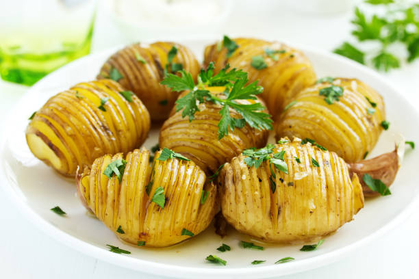 istock baked potato accordion with parsley. 1173345872