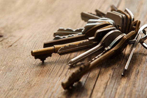 Bunch of different keys Bunch of different keys on wooden surface key ring photos stock pictures, royalty-free photos & images