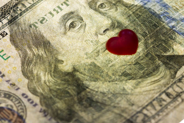 Hundred dollar banknote of usa. eyes of Franklin mouth closed by hearts . Concept financial love and a gift for Valentine`s Day Hundred dollar banknote of usa. eyes of Franklin mouth closed by hearts . Concept financial love and a gift for Valentine`s Day valentinstag stock pictures, royalty-free photos & images