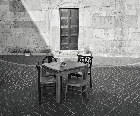 An old table on the street waiting for new people to fill their chairs with history.