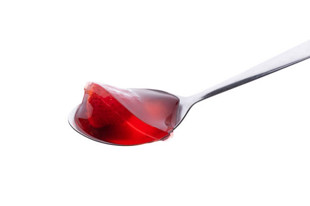 istock strawberry Jelly with spoon on isolated white background 1173348634