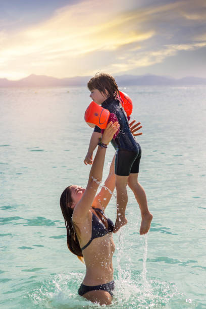 istock two sisters on vacation playing in the sea 1173350544