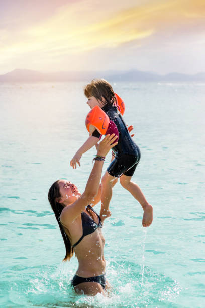 istock two sisters on vacation playing in the sea 1173350559