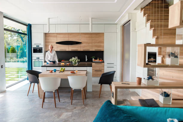 istock Happy woman standing in kitchen in smart home 1173351985