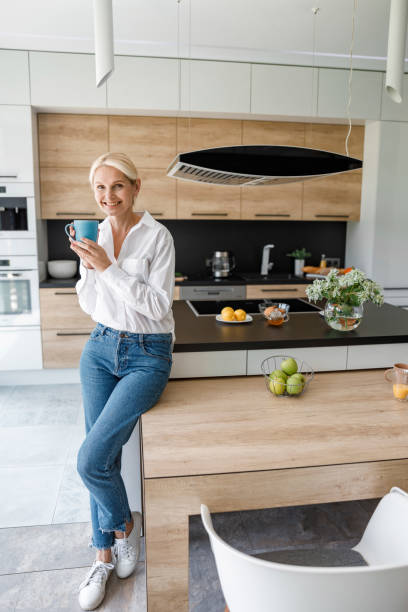 istock Smiling lady with hot drink in hands 1173352717