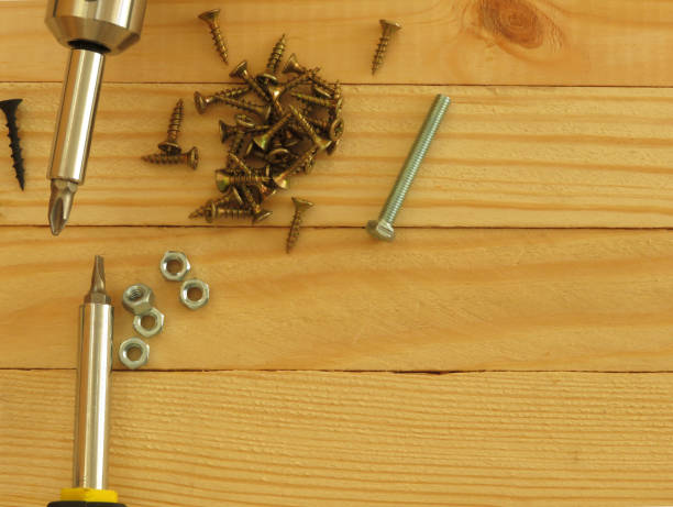 istock Set of tools. Drill, screws, screwdriver, pliers. Wood background. 1173352765