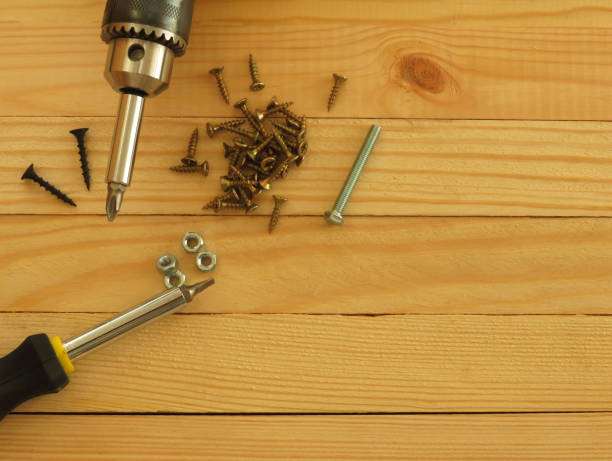 istock Set of tools. Drill, screws, screwdriver, pliers. Wood background. 1173352767