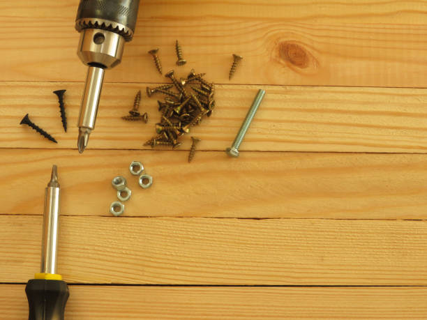 istock Set of tools. Drill, screws, screwdriver, pliers. Wood background. 1173352768