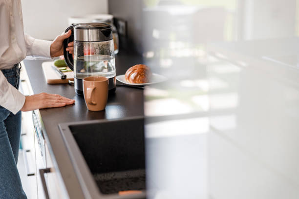 istock Woman is holding a teapot with water 1173352891