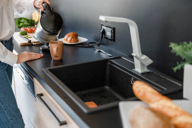 istock Woman is pouring water into a cup 1173352900