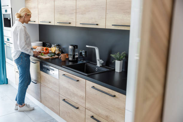 istock Happy pretty lady is standing in the kitchen 1173352946