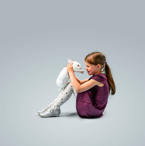 little girl with rabbit against gray background - blond hair carrying little girls small imagens e fotografias de stock