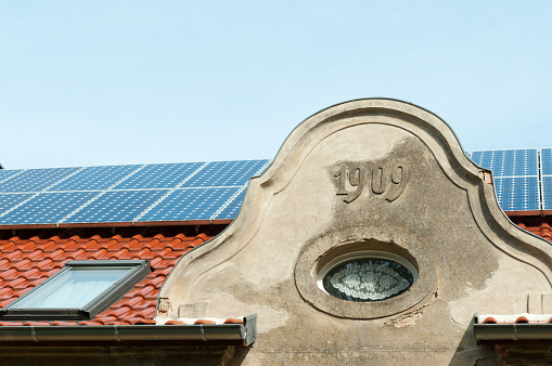 modern solar panels on a historic house roof