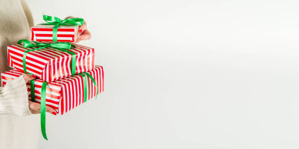 istock Female hands hold xmas gift boxes, champagne and glasses 1173354344