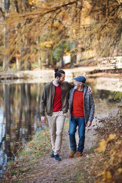 istock Senior father and his son walking in nature, talking. 1173354969