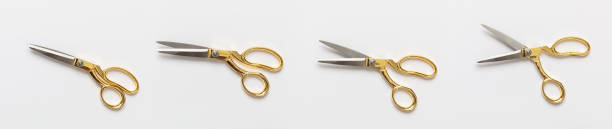Scissors gold and silver isolated against white background
