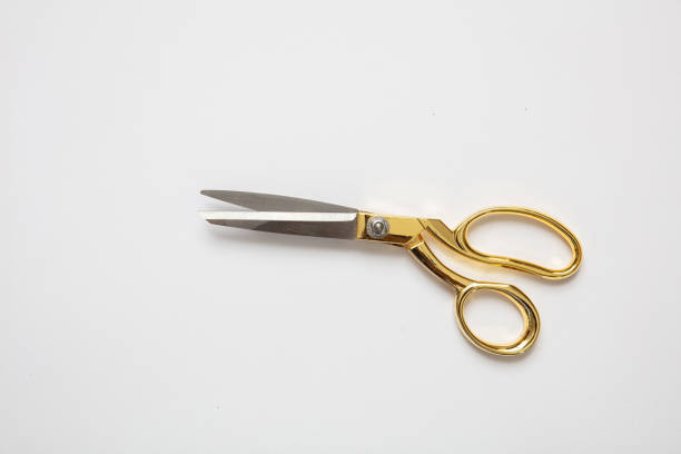 istock Scissors gold and silver isolated against white background 1173357285