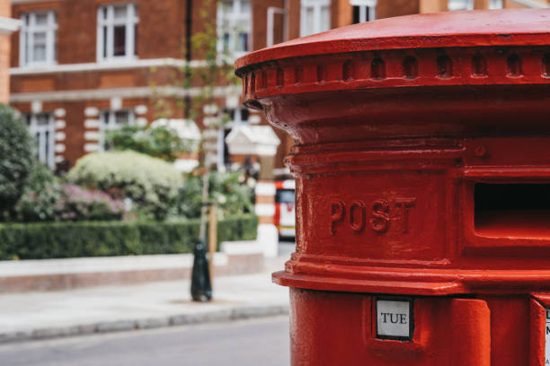 istock Red post box on a street in London, UK. 1173360080