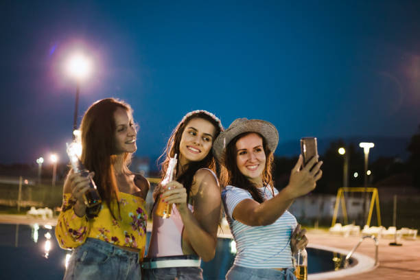 istock Women's night party at the pool 1173360592