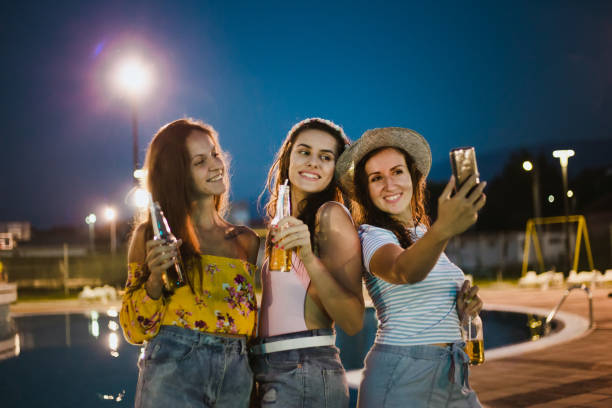 istock Women's night party at the pool 1173361660