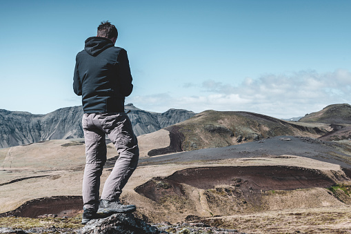 A tourist admires the Icelandic landscape.