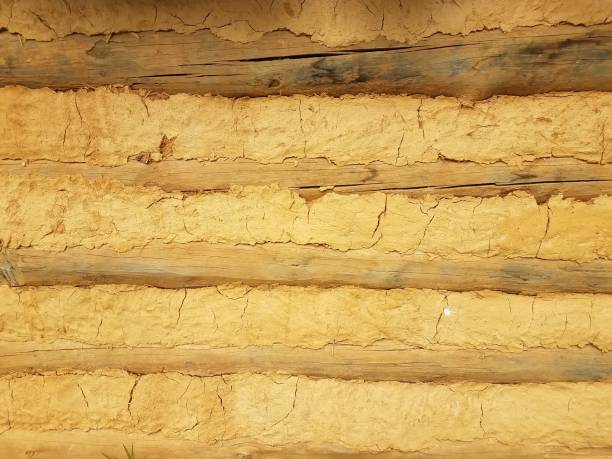 istock orange dried mud or adobe wall with wood 1173363102