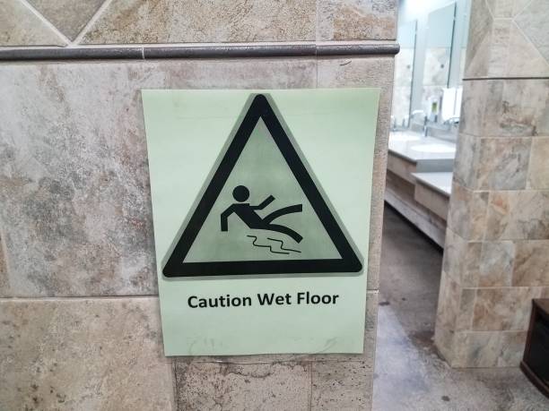istock caution wet floor sign and tiles in bathroom 1173363143