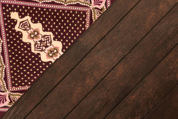 istock Muslim prayer mat or rug isolated on wood table 1173363196