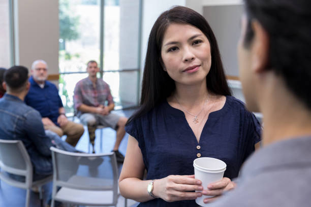 istock Attentive counselor talks with man before support group meeting 1173363314