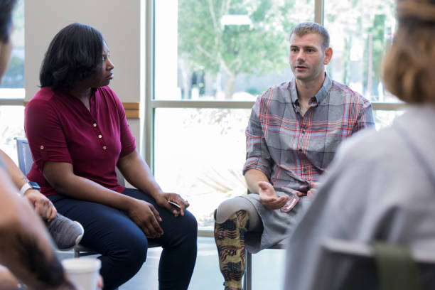 istock Man with prosthetic leg participates in discussion group 1173363361