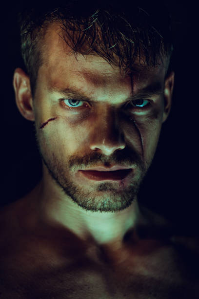 istock Spooky portrait of man on dark background 1173366771
